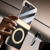 Smartphone with a reflective case held by a hand, with a car mount in the background.